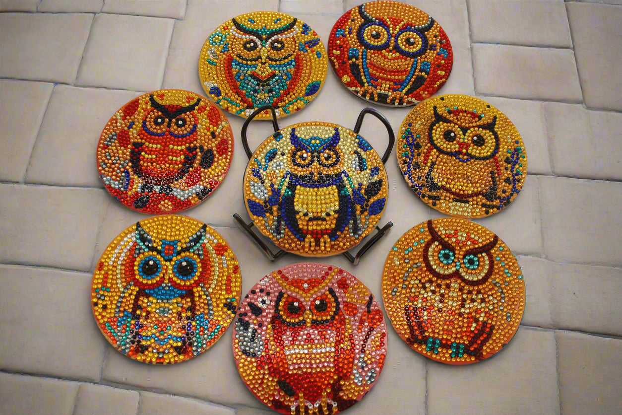 Set of colorful owl coasters on a beige background