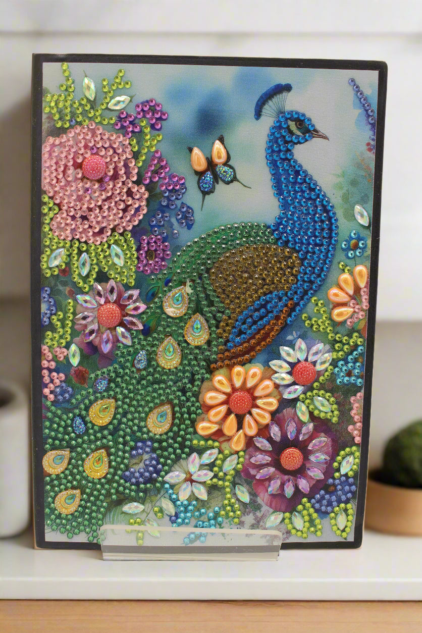 Colorful beaded artwork of a peacock and flowers on a white background