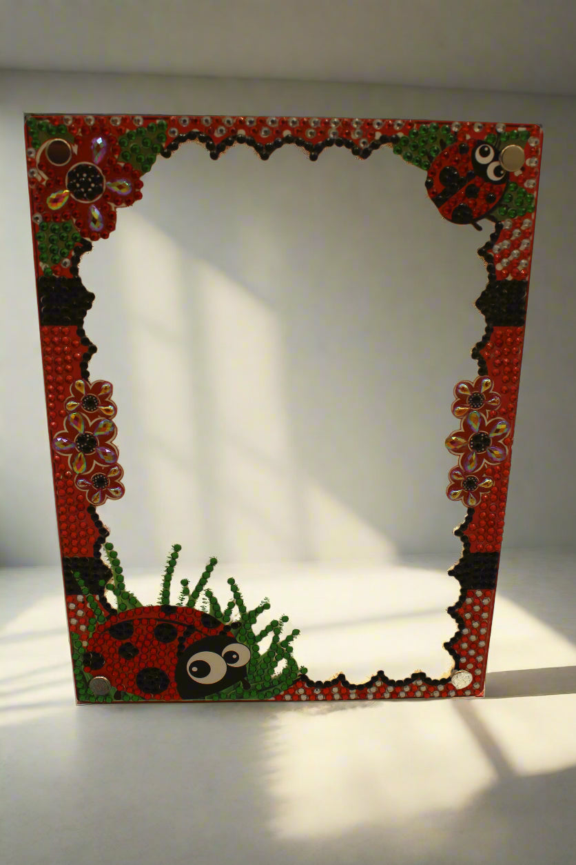 Decorative frame with ladybug and floral patterns on a beige background
