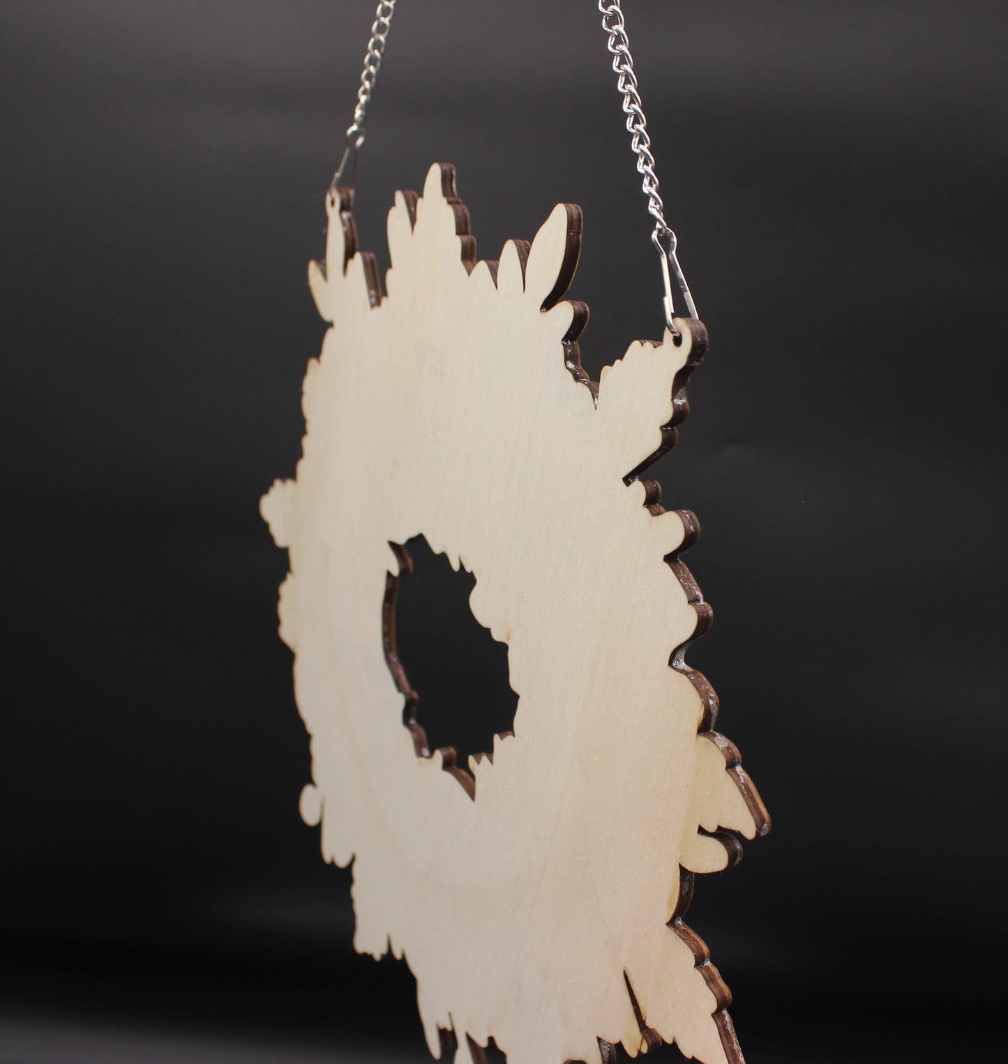 Decorative wall hanging with a black center on a dark background