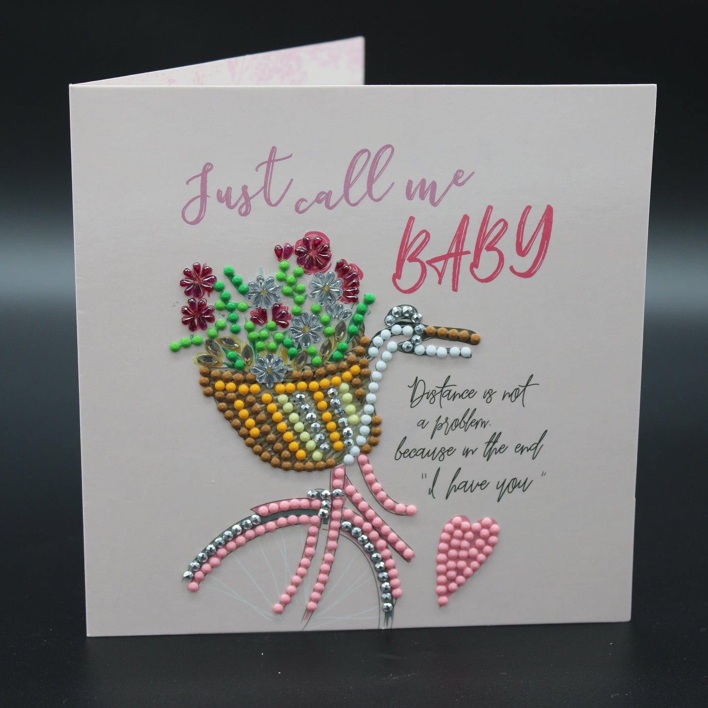 Greeting Card is Adorned with Charming Rhinestones Featuring a Carriage with a Basket of Ornate Flowers.