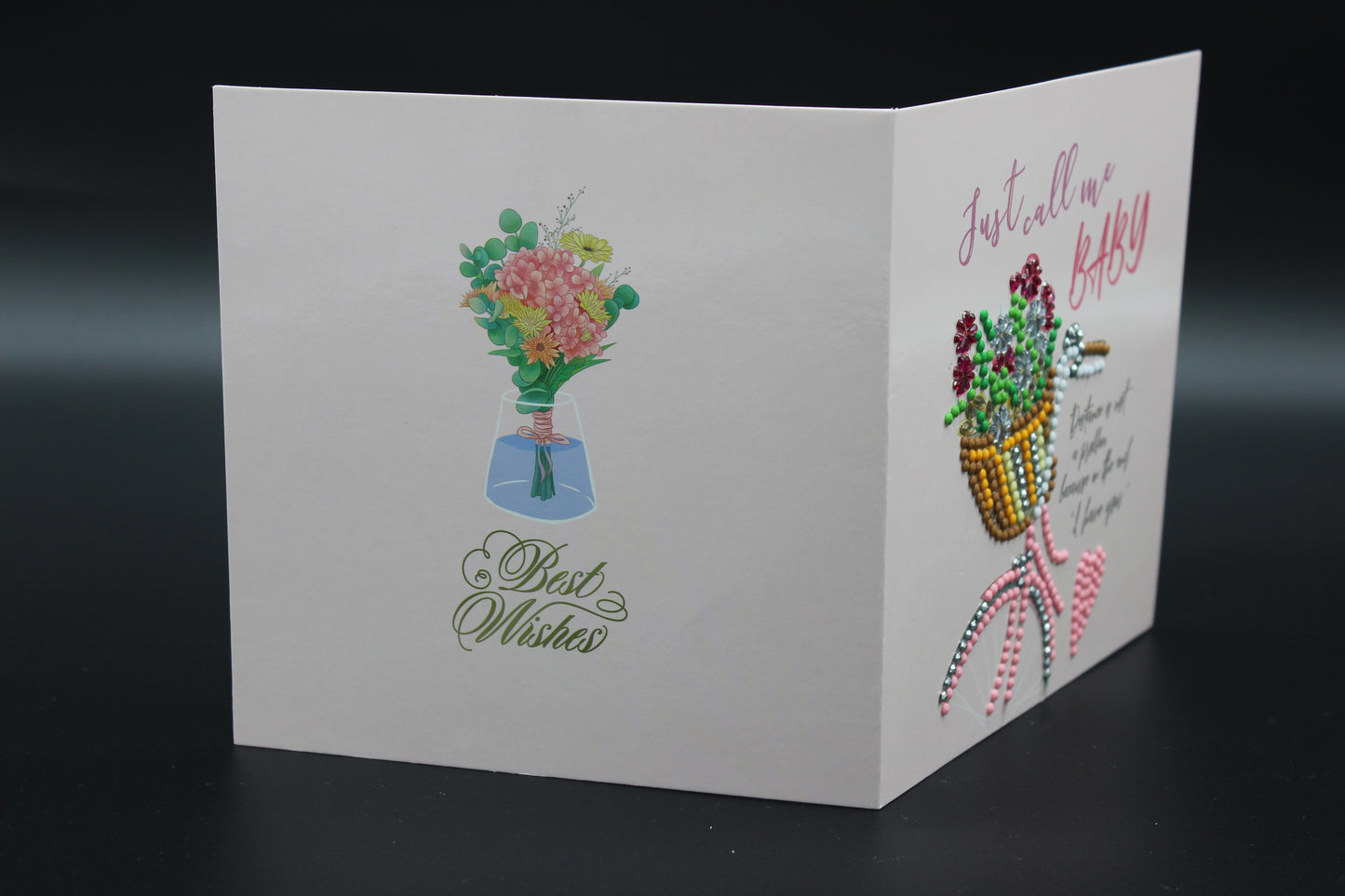 Greeting Card is Adorned with Charming Rhinestones Featuring a Carriage with a Basket of Ornate Flowers.