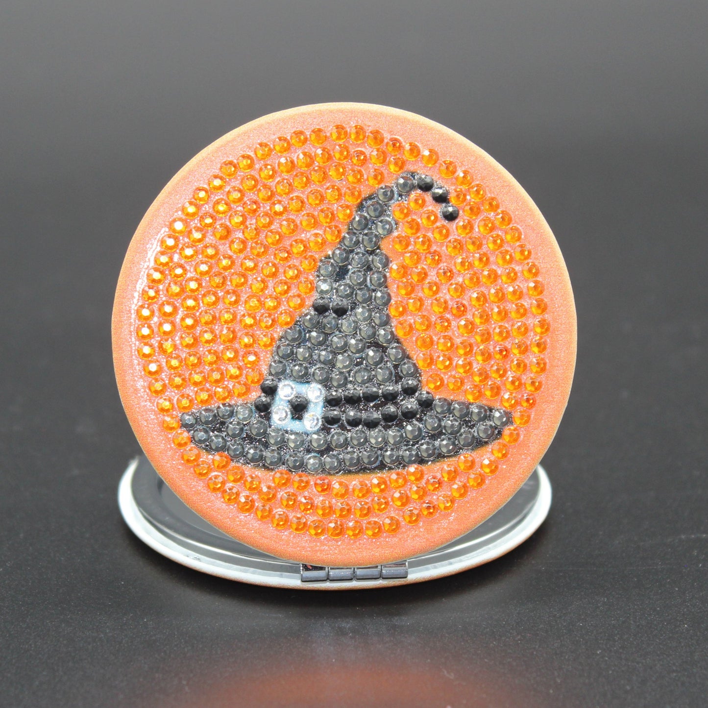 Round Shaped Halloween Compact Mirror with a Black Witches Hat and Beautiful Orange Background, all in Crystal Rhinestones