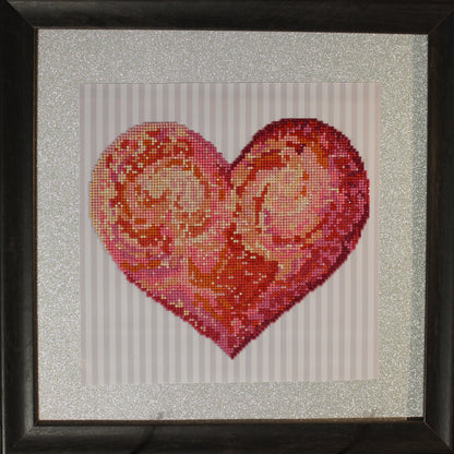 Diamond Art Painting with Colorful Hues of Red and Pink in a Single Large Heart with a Silver Background.