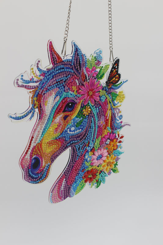 Colorful beaded unicorn with floral details on a white background