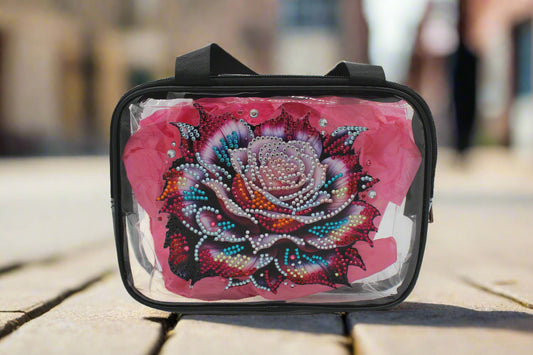 Clear cosmetic bag with a decorative rose design on a white background