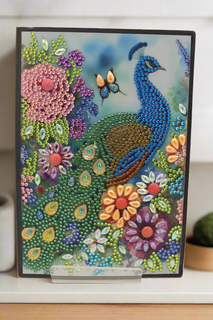 Colorful beaded artwork of a peacock and flowers on a white background