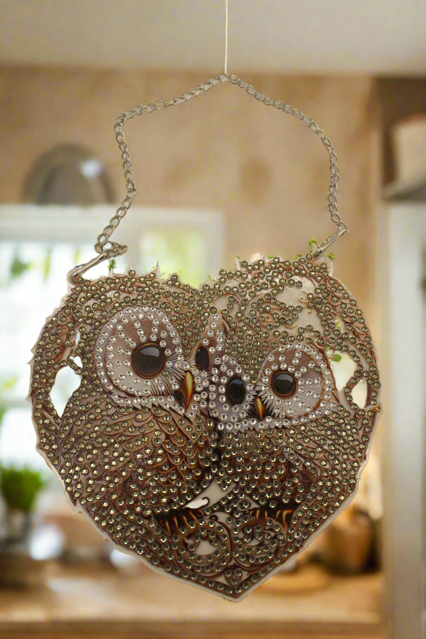 Decorative handbag with intricate designs and a chain strap on a beige background