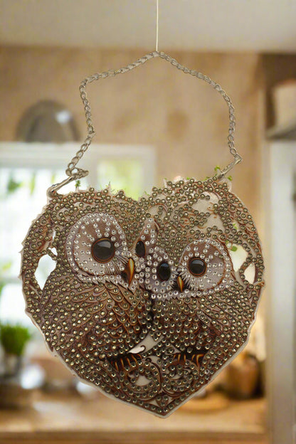 Decorative handbag with intricate designs and a chain strap on a beige background