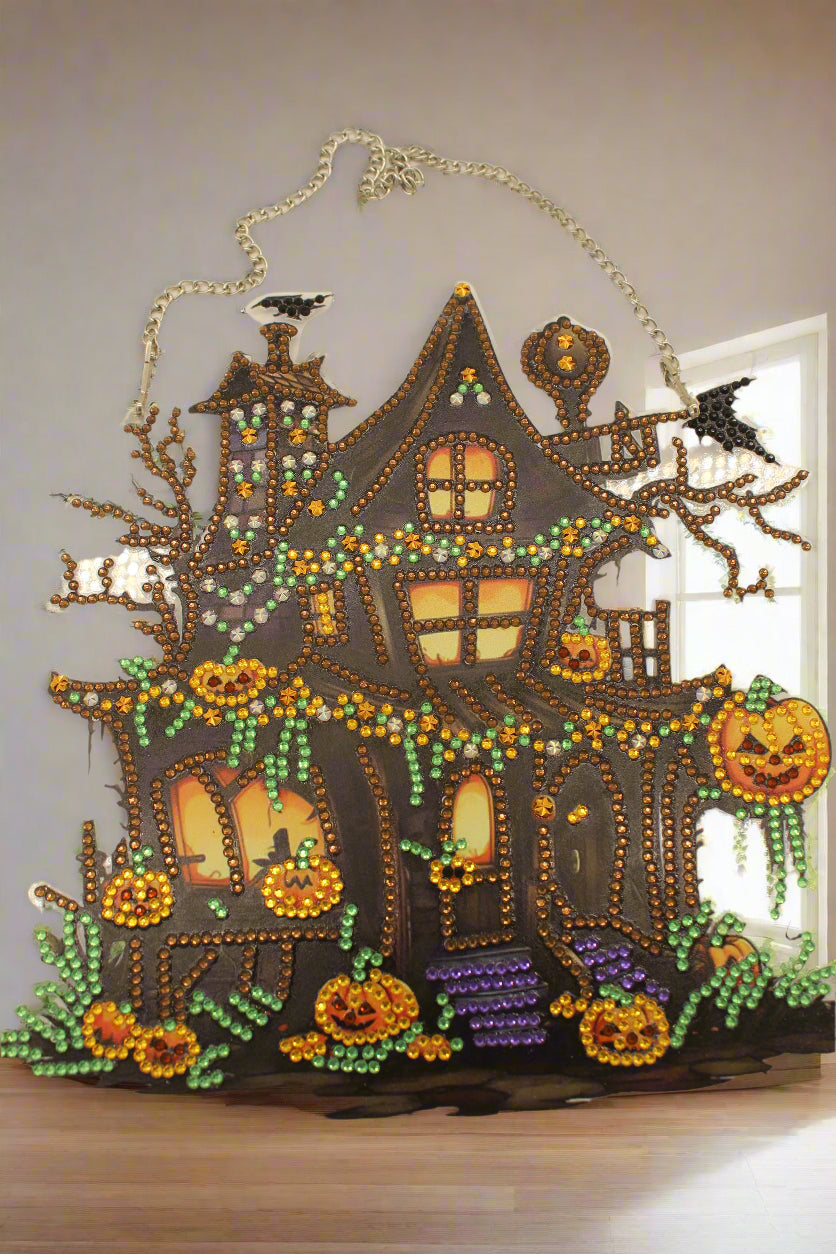 Decorative Halloween-themed house with beaded details on a beige background