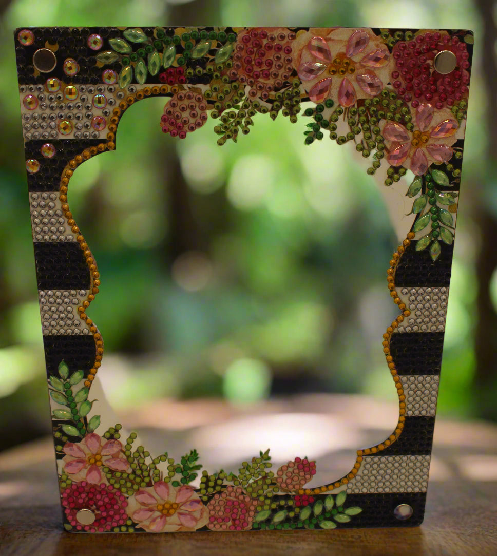 Decorative frame with floral patterns and embellishments on a plain background