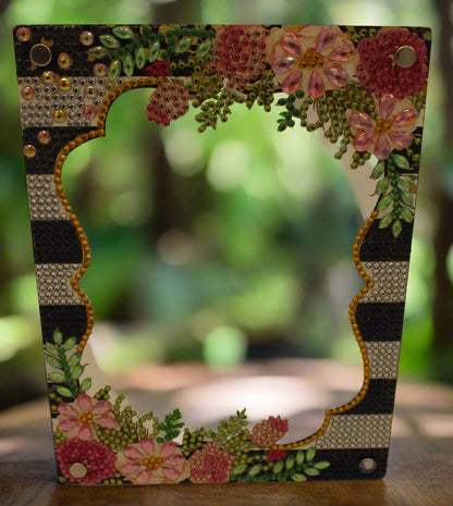 Decorative frame with floral patterns and embellishments on a plain background