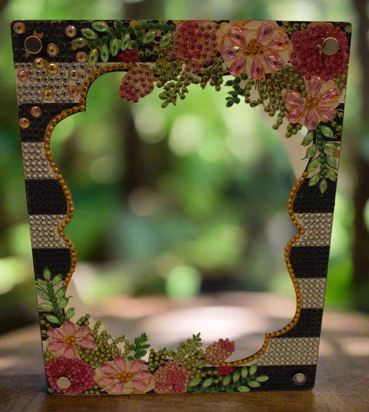 Decorative frame with floral patterns and embellishments on a plain background