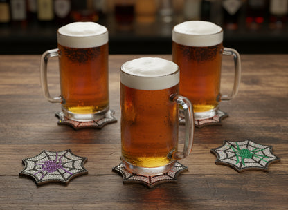 Spider web coasters with colorful spider designs on a dark background