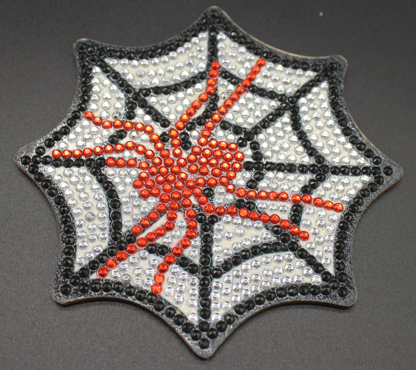 Spider web and spider design patch on a dark background