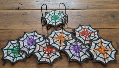 Set of spider web-shaped patches with colorful centers on a dark background
