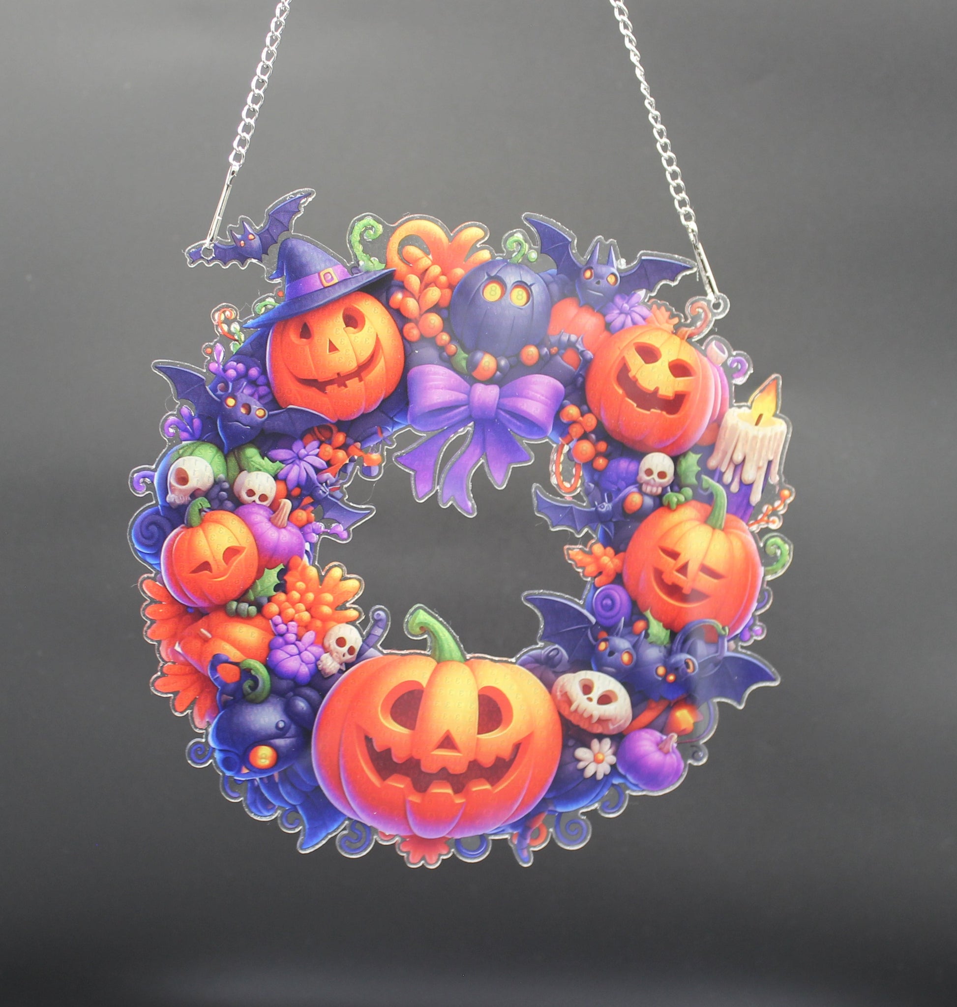 Halloween-themed wreath with pumpkins and ghosts on a black background