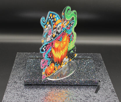 Colorful butterfly sculpture on a reflective surface with a dark background