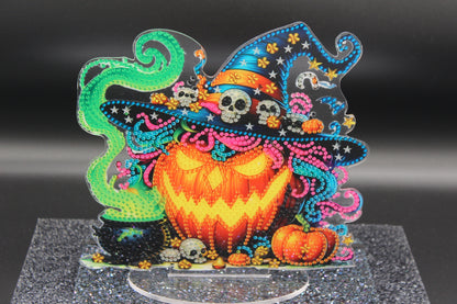 Colorful Halloween-themed decorative piece with a jack-o'-lantern, witch hat, and ghosts on a dark background.