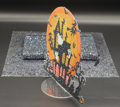 Decorative butterfly ornament on a stand against a dark background