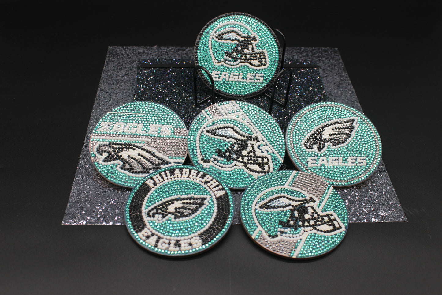 Set of Philadelphia Eagles-themed coasters with rhinestone embellishments on a dark background
