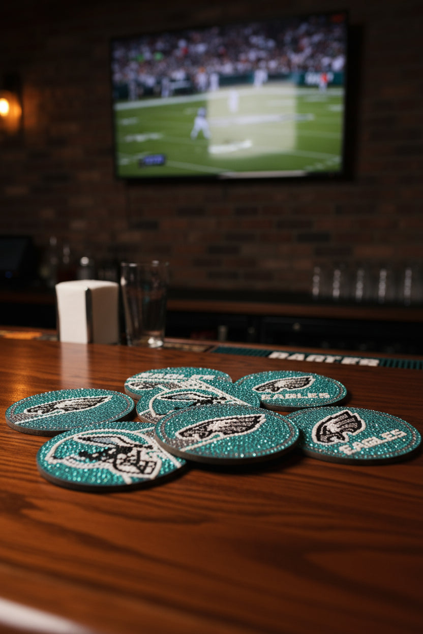 Set of rhinestone coasters with a sports team logo on a black surface