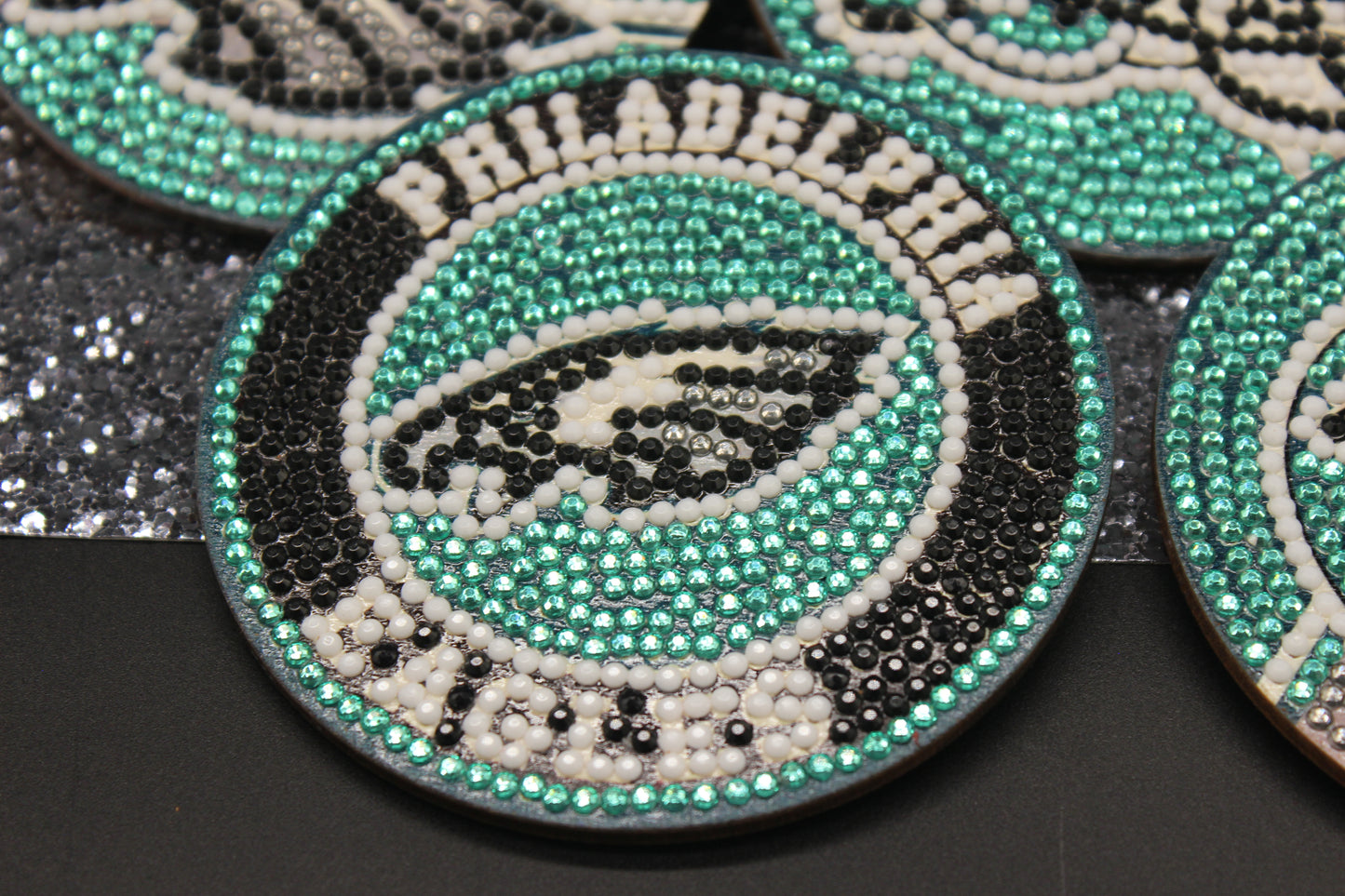Decorative coasters with Philadelphia Eagles logo and text on a black background