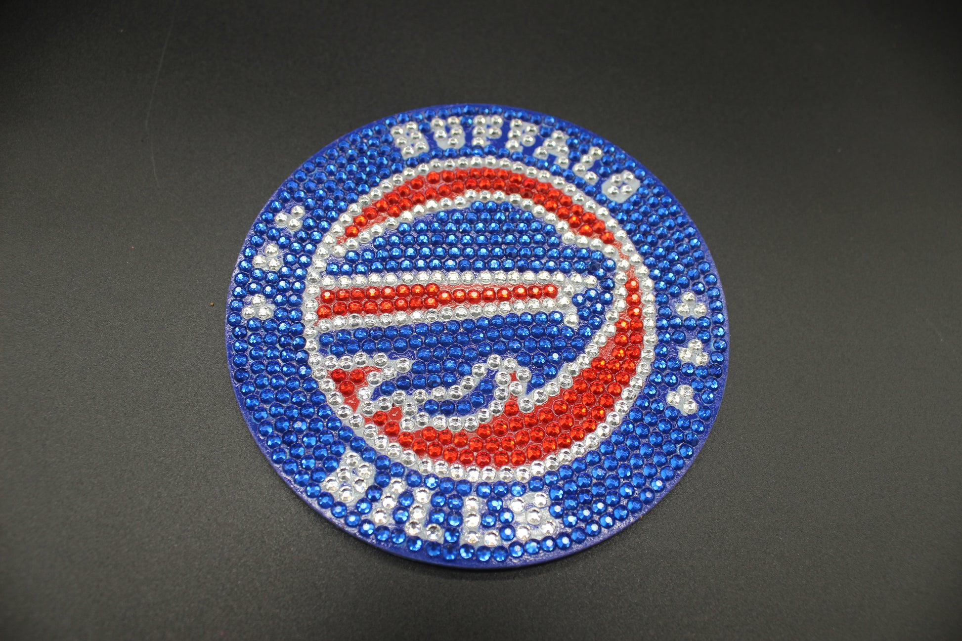 Beaded Buffalo Bills logo on a dark background