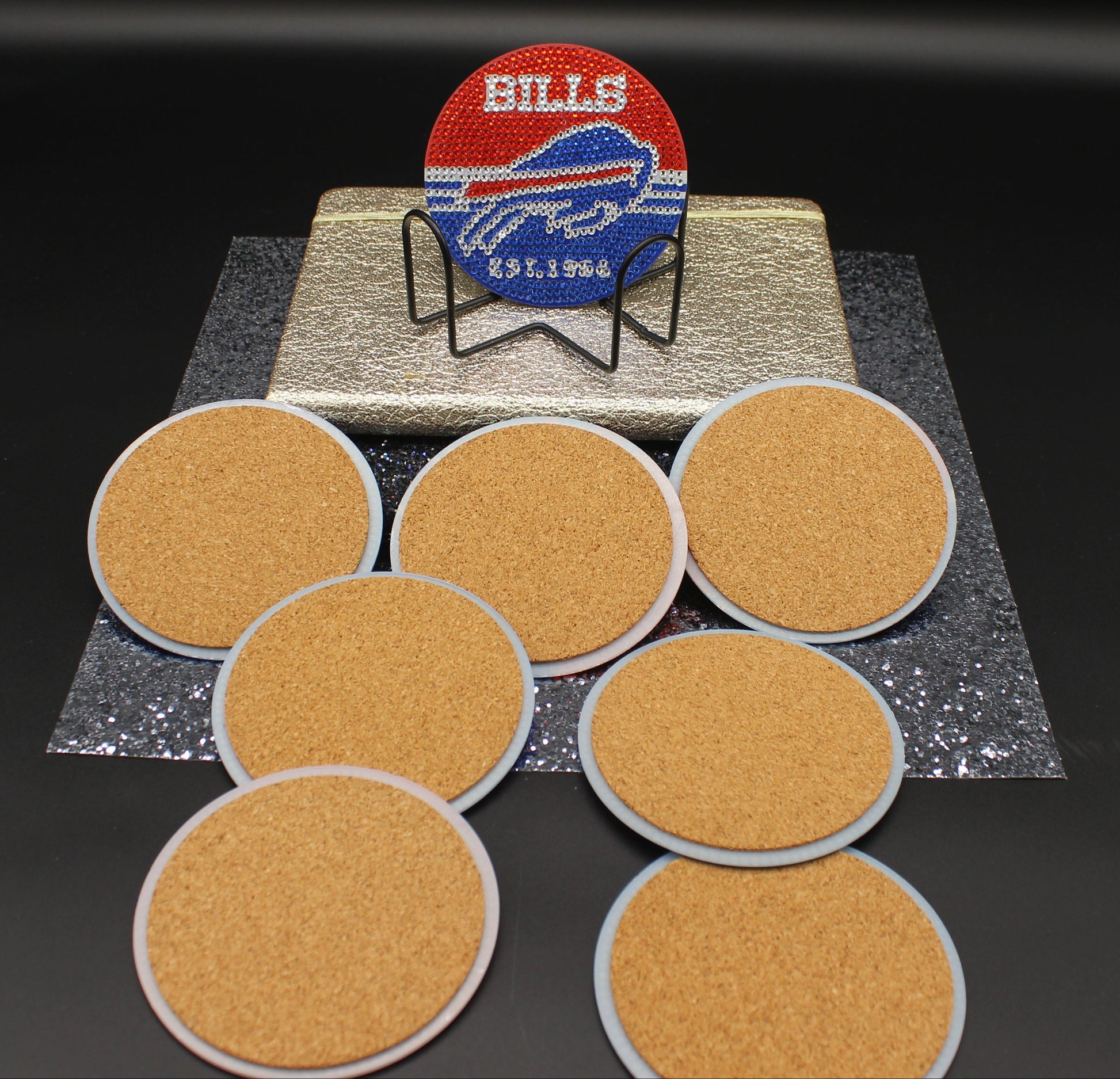 Set of six round cork coasters with a Buffalo Bills logo coaster on a black background