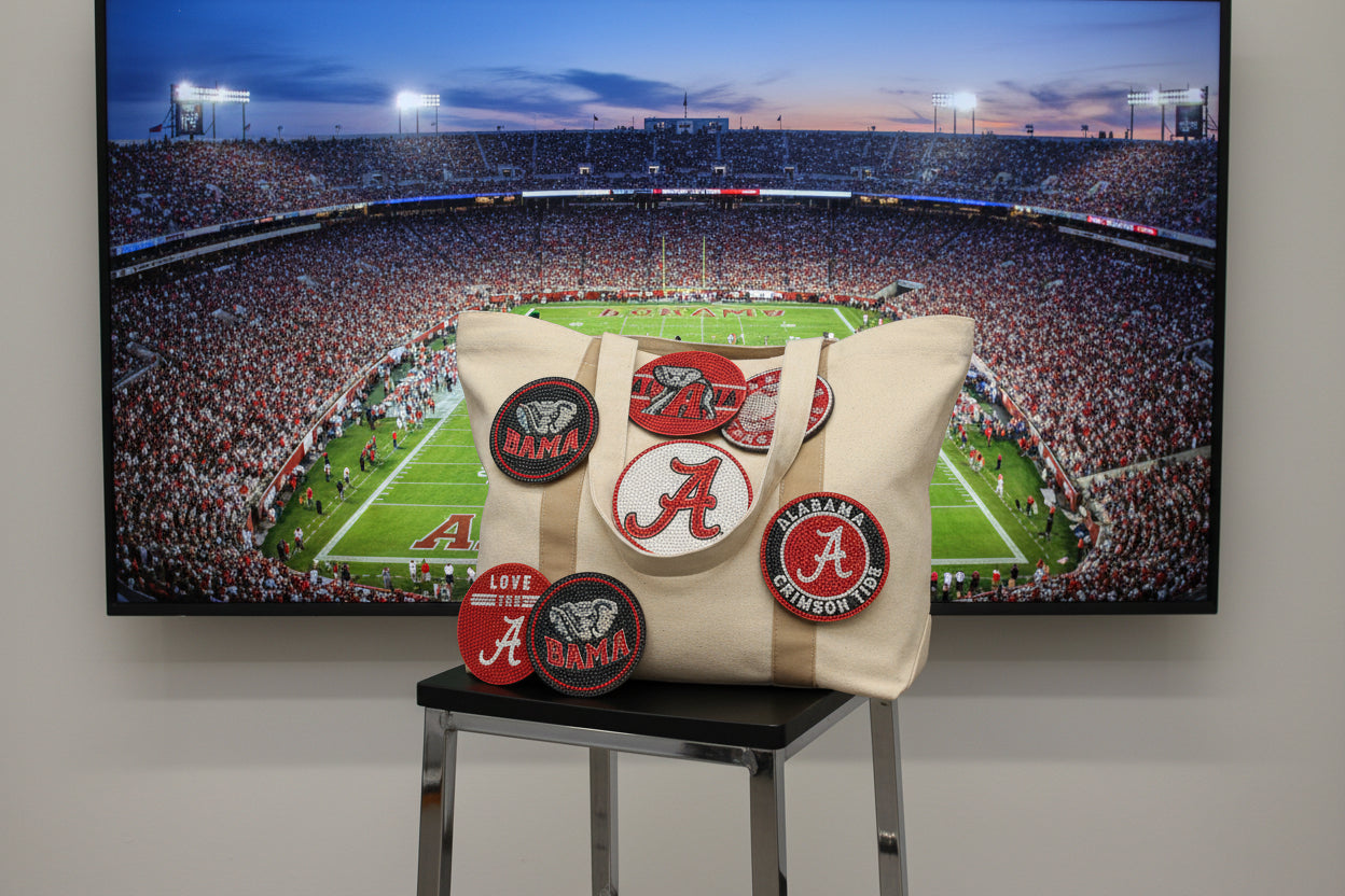 Collection of Alabama Crimson Tide-themed coasters on a dark surface