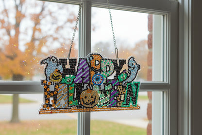 Decorative Halloween sign with colorful letters and characters on a dark background