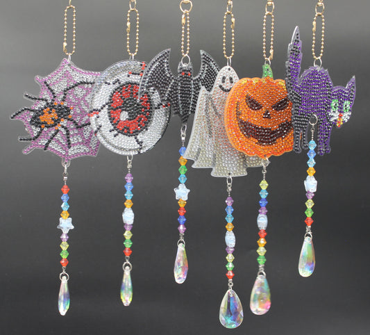 Halloween-themed beaded decorations hanging on a rod against a dark background