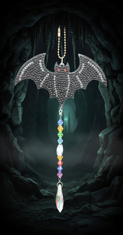 Decorative car charm shaped like a bat with colorful beads on a plain background