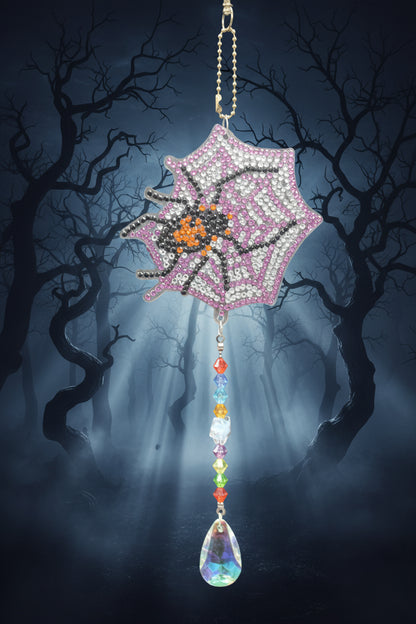 Decorative hair clip with spider and web design on a gray background