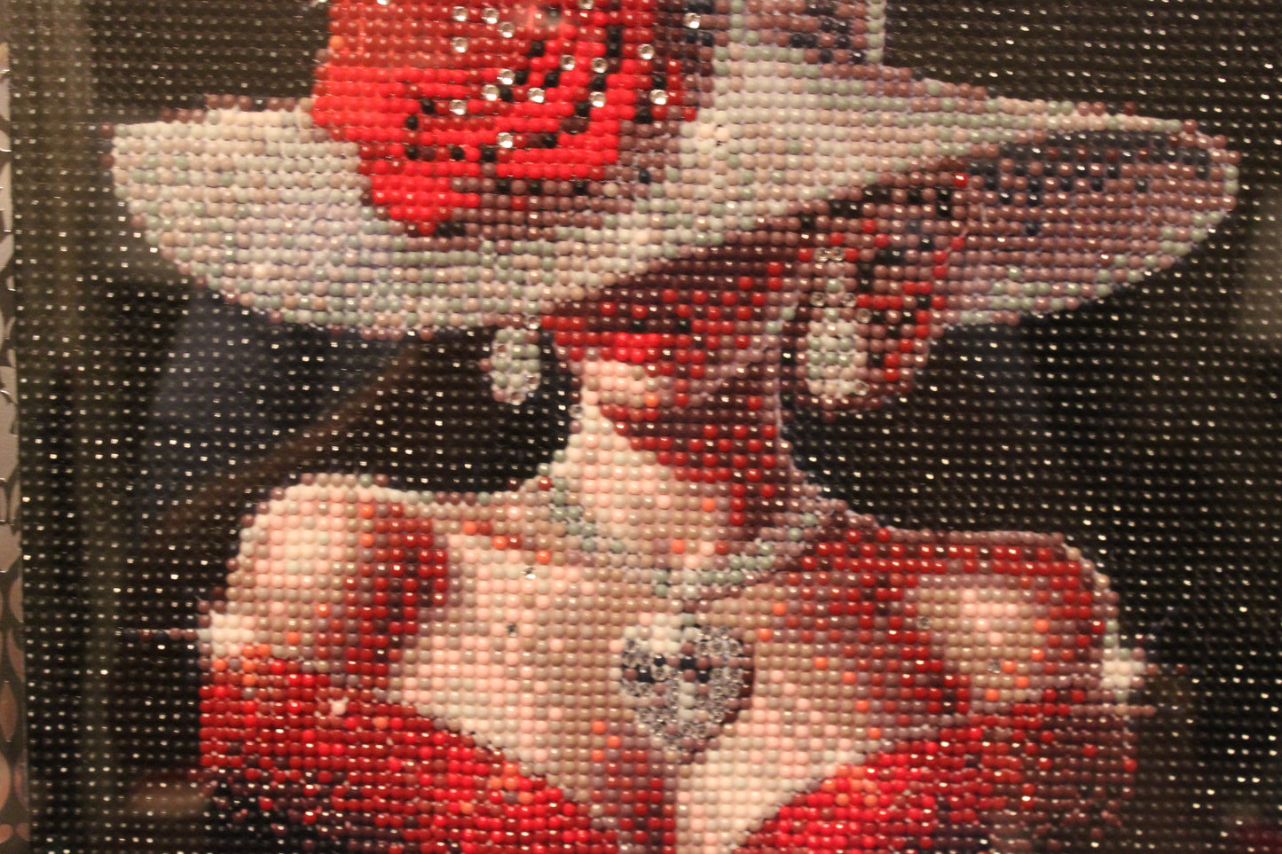 Decorative piece with a woman wearing a red dress, white hat, and necklace.