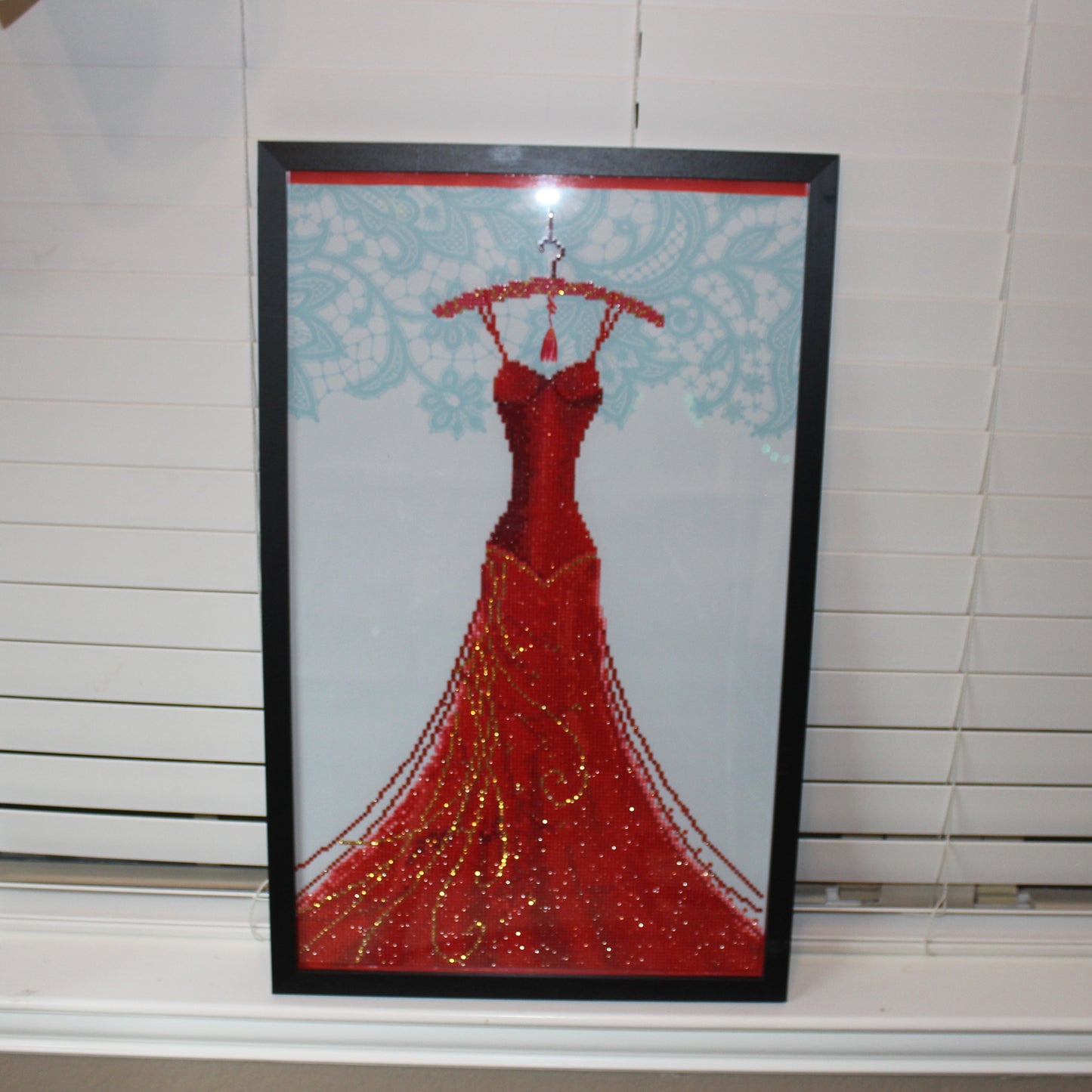 Gorgeous Diamond Art Red Dress Hanging on a Red Clothes Hanger
