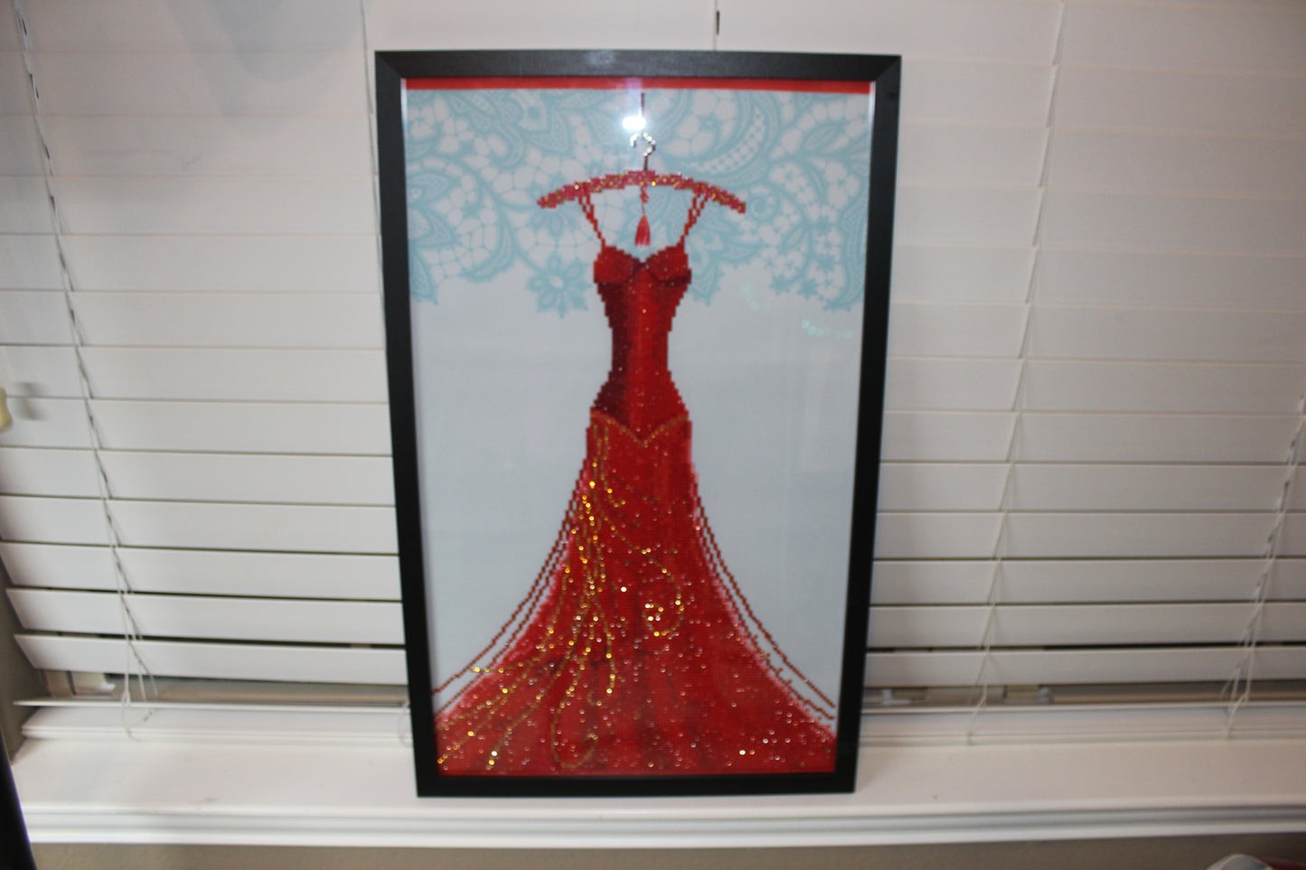 Gorgeous Diamond Art Red Dress Hanging on a Red Clothes Hanger