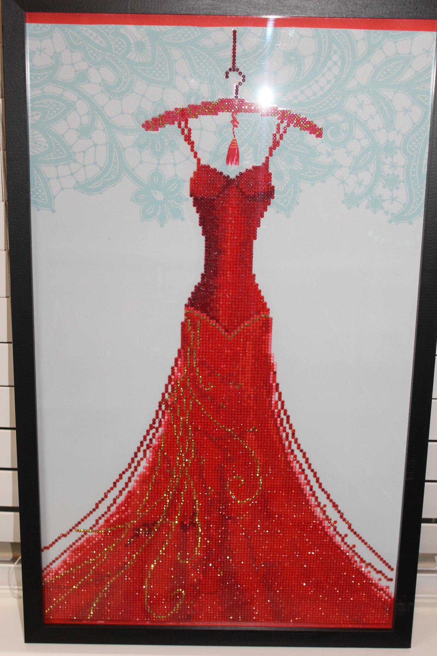 Gorgeous Diamond Art Red Dress Hanging on a Red Clothes Hanger
