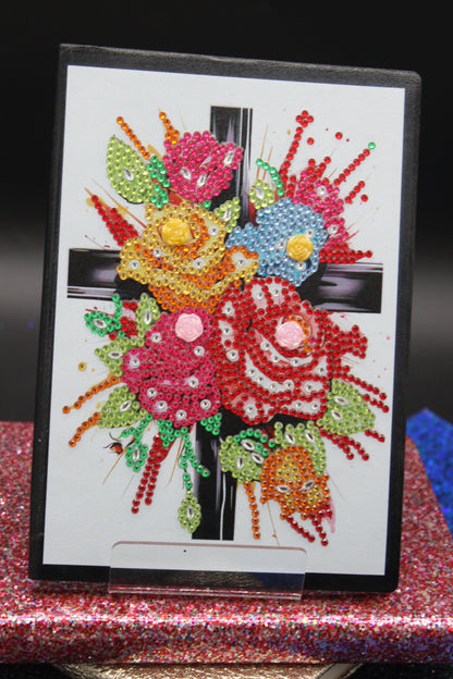 Diamond Art Journal With Multi Colored Flower Adorned to a Cross